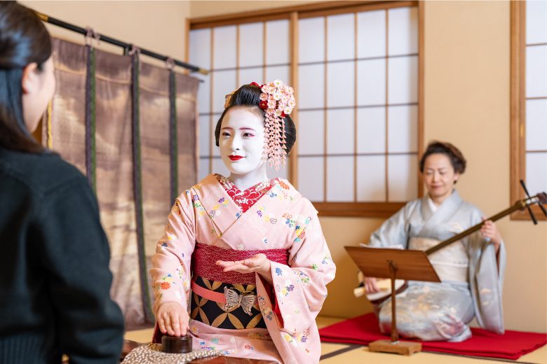 Intimate tatami dining room prepared for a kaiseki evening with traditional entertainment