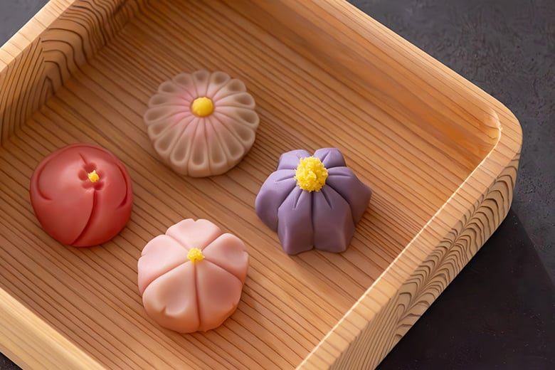 Delicate wagashi sweets and tea arranged on a refined tabletop in Tokyo